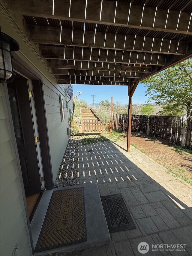 view of patio / terrace featuring fence