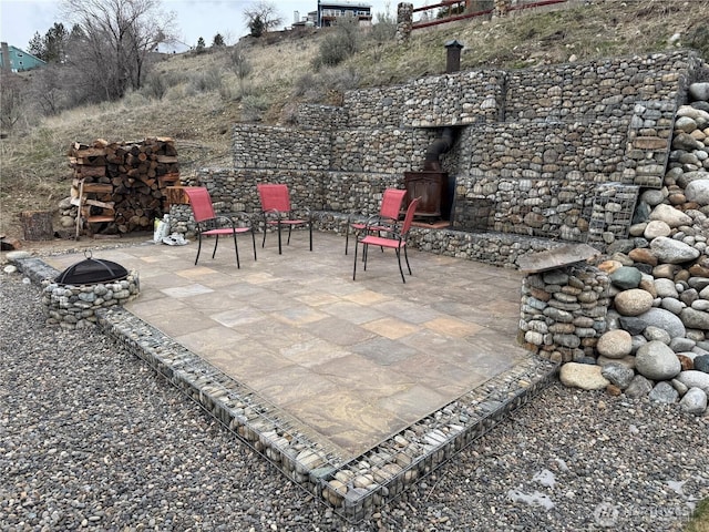 view of patio with an outdoor fire pit