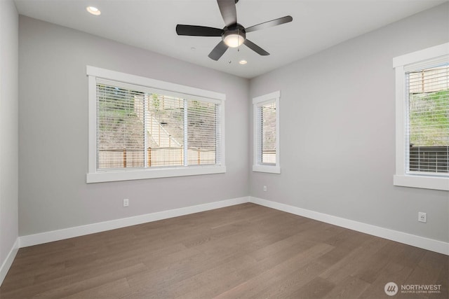empty room featuring recessed lighting, baseboards, ceiling fan, and dark wood-type flooring