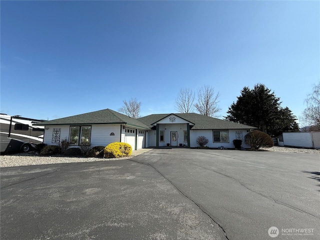 ranch-style house featuring driveway and an attached garage