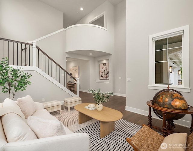 1497 Elk Run Pl SE, North Bend, WA 98045 - living room with wood finished floors, a high ceiling, stairway, baseboards, and recessed lighting