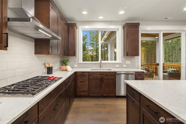 1497 Elk Run Pl SE, North Bend, WA 98045 - kitchen featuring appliances with stainless steel finishes, wall chimney range hood, a sink, dark wood finished floors, and decorative backsplash