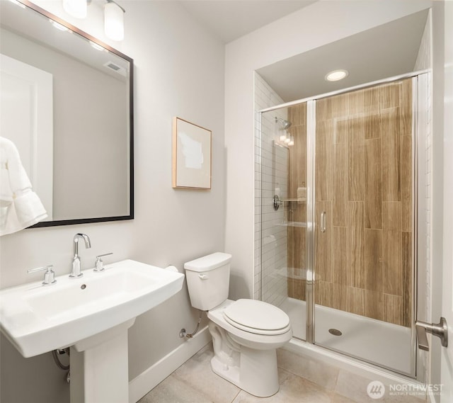 1497 Elk Run Pl SE, North Bend, WA 98045 - bathroom with toilet, a stall shower, tile patterned flooring, a sink, and baseboards
