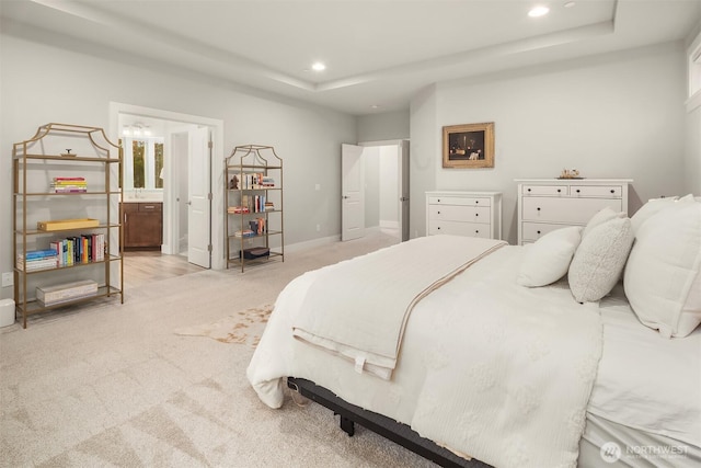 1497 Elk Run Pl SE, North Bend, WA 98045 - bedroom with light colored carpet, a tray ceiling, recessed lighting, ensuite bath, and baseboards