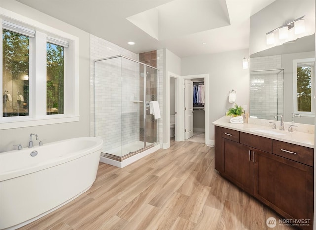 1497 Elk Run Pl SE, North Bend, WA 98045 - bathroom with a stall shower, vanity, a freestanding bath, and wood finished floors