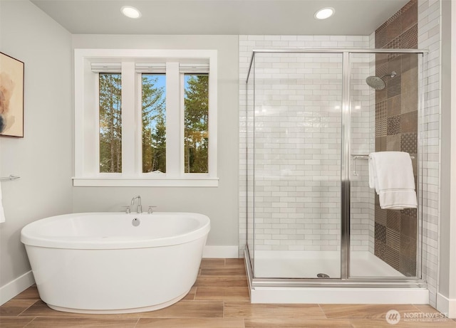 1497 Elk Run Pl SE, North Bend, WA 98045 - bathroom with baseboards, a stall shower, a freestanding tub, recessed lighting, and wood finished floors