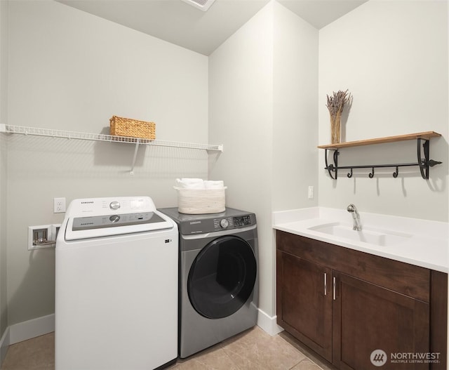 1497 Elk Run Pl SE, North Bend, WA 98045 - laundry room with washing machine and clothes dryer, cabinet space, baseboards, and light tile patterned floors