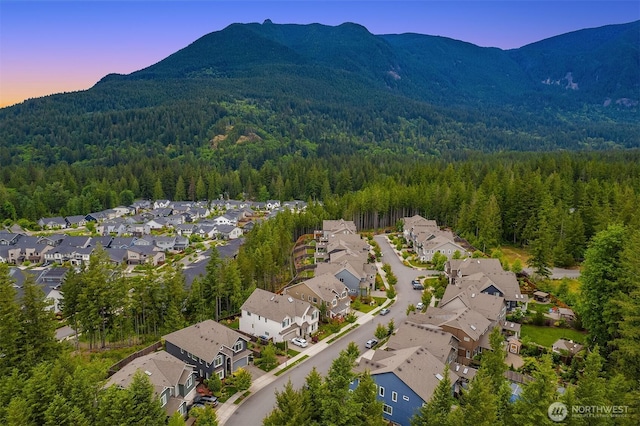 1497 Elk Run Pl SE, North Bend, WA 98045 - aerial view at dusk of a view of trees, a mountain view, and a residential view