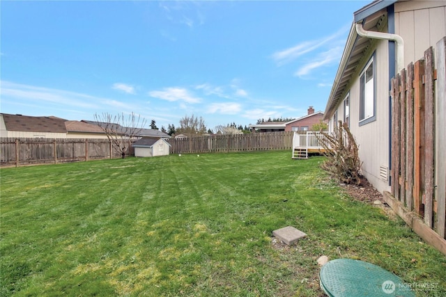 1529 Thompson Dr, Camano Island, WA 98282 - view of yard with an outbuilding, a wooden deck, a storage shed, and a fenced backyard