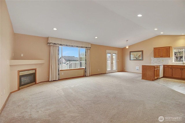 1529 Thompson Dr, Camano Island, WA 98282 - unfurnished living room featuring lofted ceiling, a glass covered fireplace, recessed lighting, baseboards, and light colored carpet