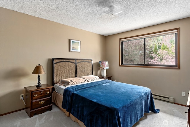 bedroom with a baseboard heating unit, light carpet, baseboards, and a textured ceiling