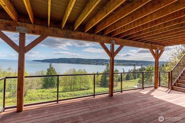 wooden deck featuring stairs and a water view