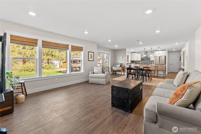 living room with baseboards, recessed lighting, and wood finished floors