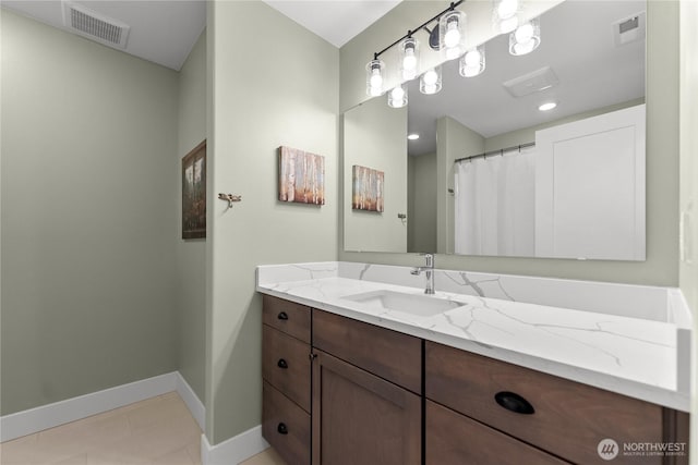 bathroom with baseboards, visible vents, tile patterned flooring, and vanity