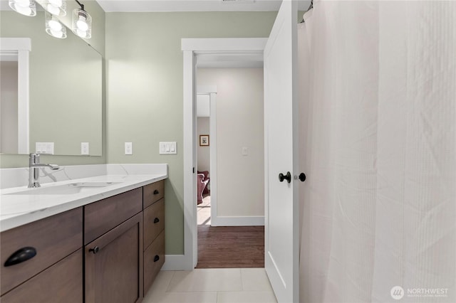bathroom featuring tile patterned flooring, baseboards, and vanity