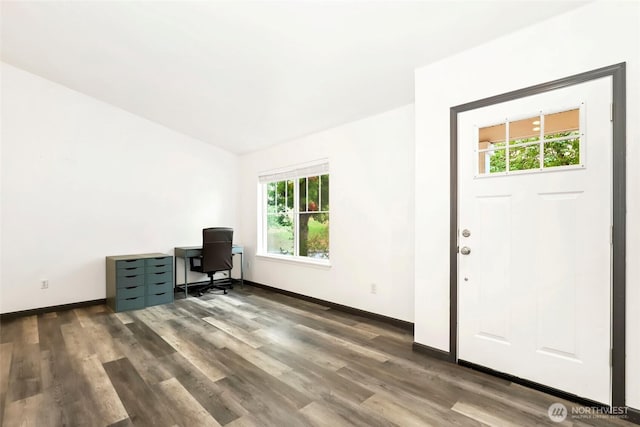 unfurnished office with baseboards and wood finished floors