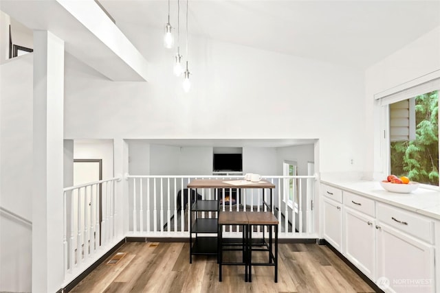 dining space with visible vents, a wealth of natural light, and wood finished floors