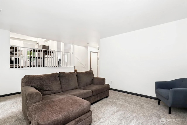 living room with light carpet and baseboards