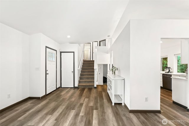 entrance foyer with dark wood-style flooring, baseboards, stairs, and recessed lighting
