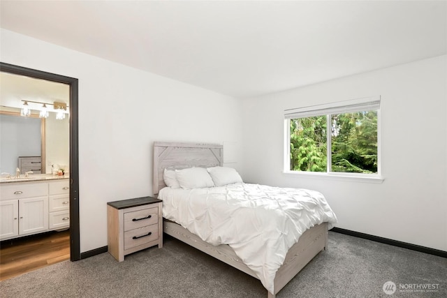 bedroom featuring connected bathroom, baseboards, and carpet