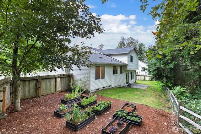 view of yard featuring a fenced backyard and a vegetable garden
