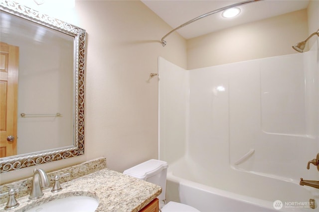 full bath featuring recessed lighting, toilet, vanity, and bathing tub / shower combination