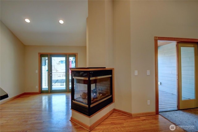 interior space featuring baseboards, light wood-style floors, and recessed lighting