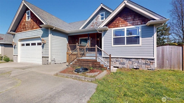 view of front of home with fence, a front lawn, concrete driveway, an attached garage, and a porch