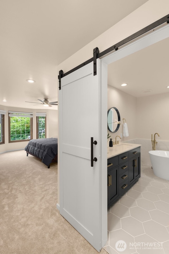4381 239th Pl SE, Sammamish, WA 98029 - ensuite bathroom featuring recessed lighting, double vanity, a freestanding tub, and a ceiling fan