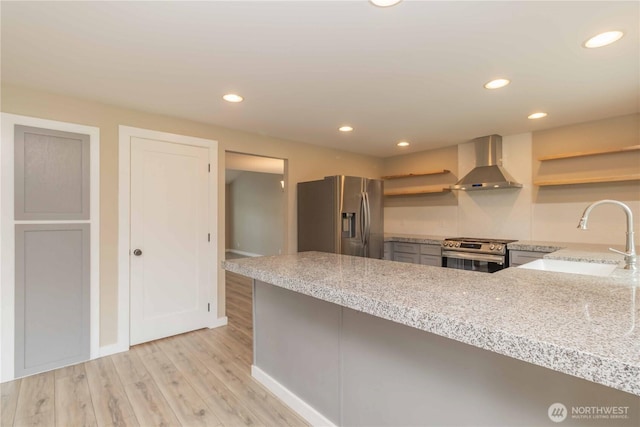 kitchen featuring a sink, wall chimney exhaust hood, open shelves, and appliances with stainless steel finishes