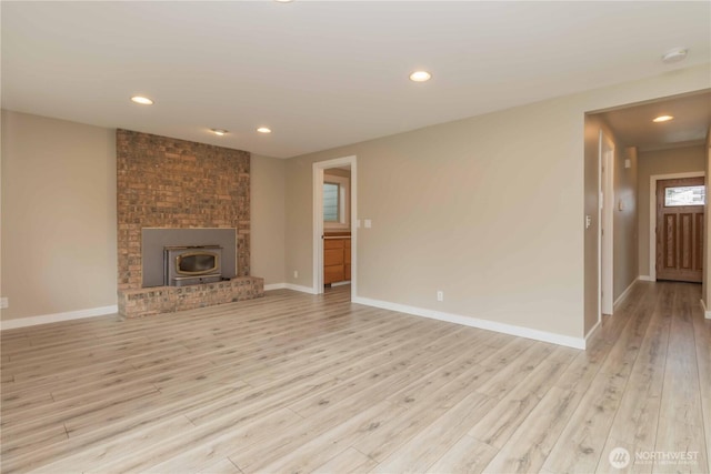 unfurnished living room with baseboards, light wood-style flooring, and recessed lighting
