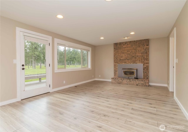 unfurnished living room featuring baseboards, wood finished floors, and recessed lighting