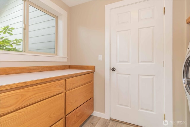 bathroom with baseboards and wood finished floors