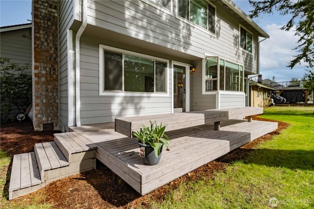 rear view of property with a lawn and a deck