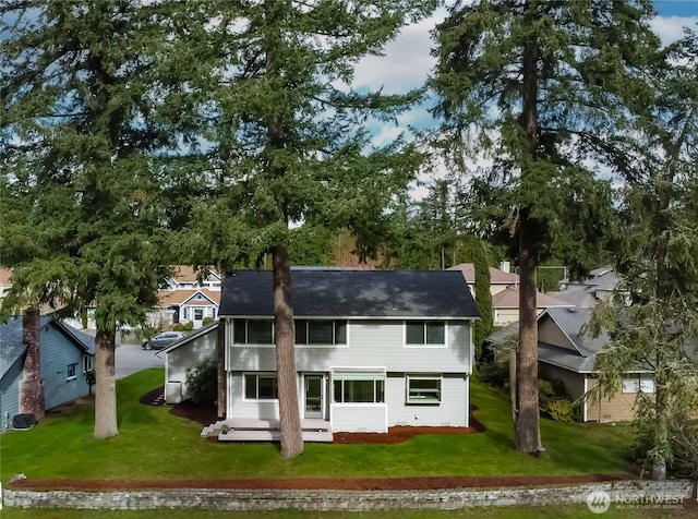 rear view of property with a lawn