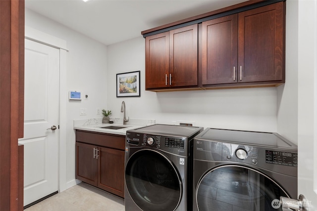 clothes washing area with independent washer and dryer, a sink, and cabinet space