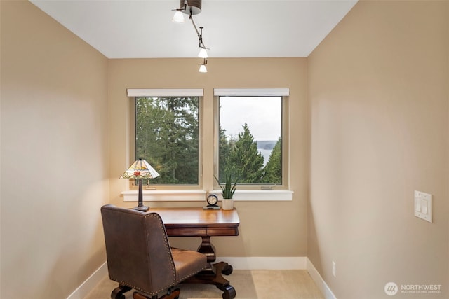carpeted office space featuring baseboards