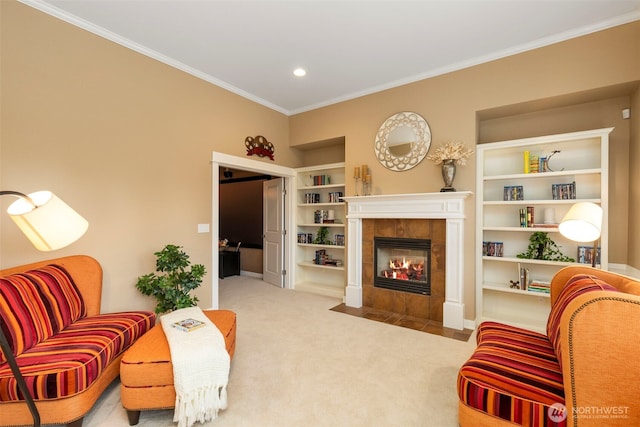 carpeted living room featuring crown molding, a tiled fireplace, recessed lighting, and built in shelves