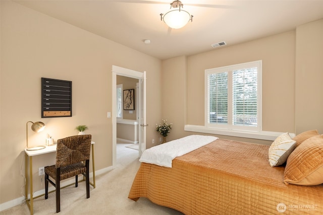 bedroom featuring baseboards, light colored carpet, and visible vents