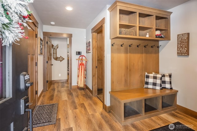 mudroom with recessed lighting, baseboards, and wood finished floors