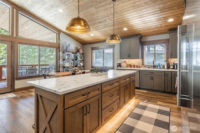 kitchen featuring a kitchen island, wooden ceiling, tasteful backsplash, and dishwasher