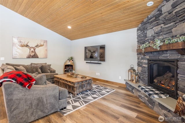 living area featuring wood finished floors, a stone fireplace, recessed lighting, wood ceiling, and vaulted ceiling