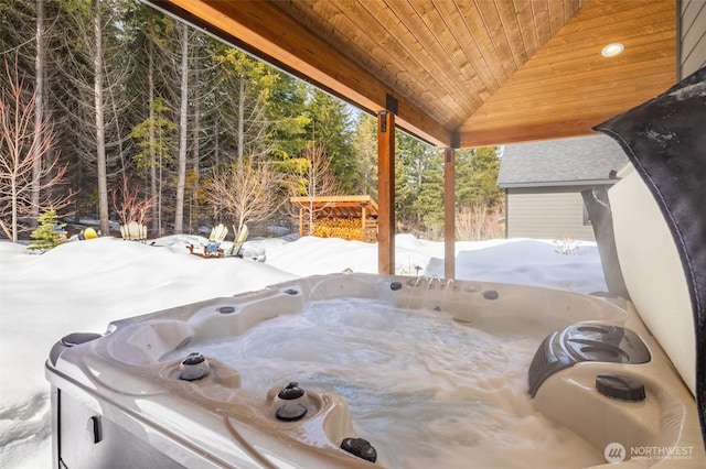 snow covered patio featuring a hot tub