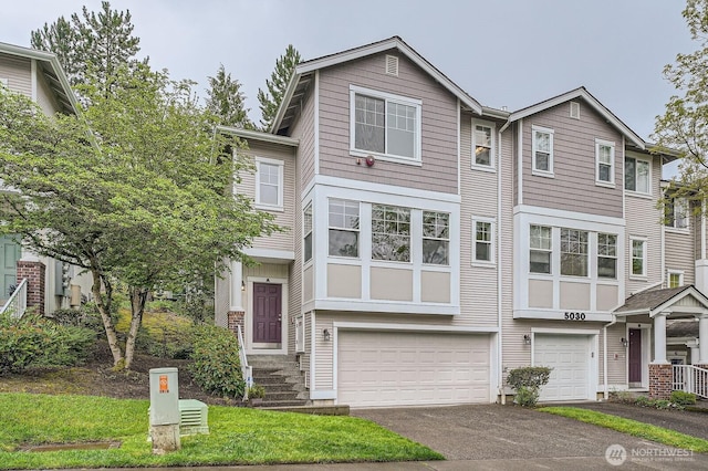 multi unit property with a garage and driveway