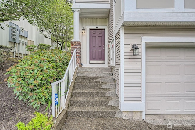 doorway to property with a garage