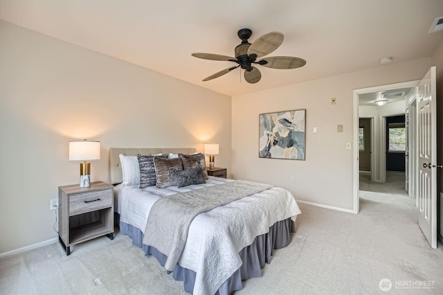 bedroom with baseboards, visible vents, ceiling fan, and light colored carpet