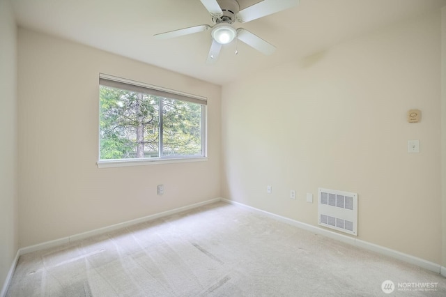 spare room with light colored carpet, baseboards, and visible vents