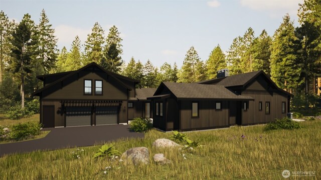 581 Wanawish Loop, Cle Elum, WA 98922 - view of front of property featuring an attached garage, a chimney, and driveway