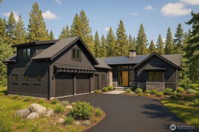 581 Wanawish Loop, Cle Elum, WA 98922 - view of front of property featuring a chimney, asphalt driveway, stone siding, board and batten siding, and an attached garage