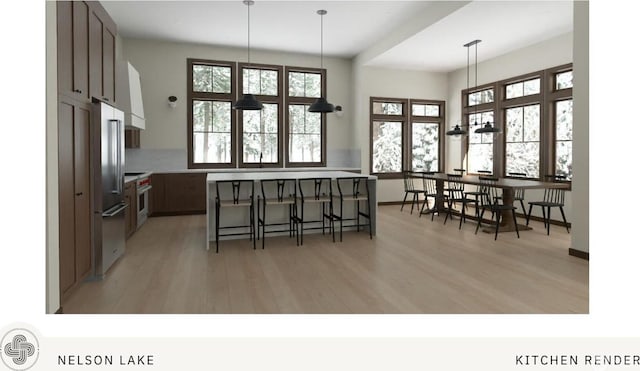 581 Wanawish Loop, Cle Elum, WA 98922 - kitchen with stainless steel appliances, light wood-style floors, a breakfast bar area, hanging light fixtures, and tasteful backsplash